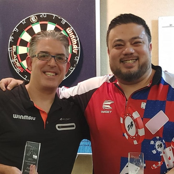 two darts players smiling