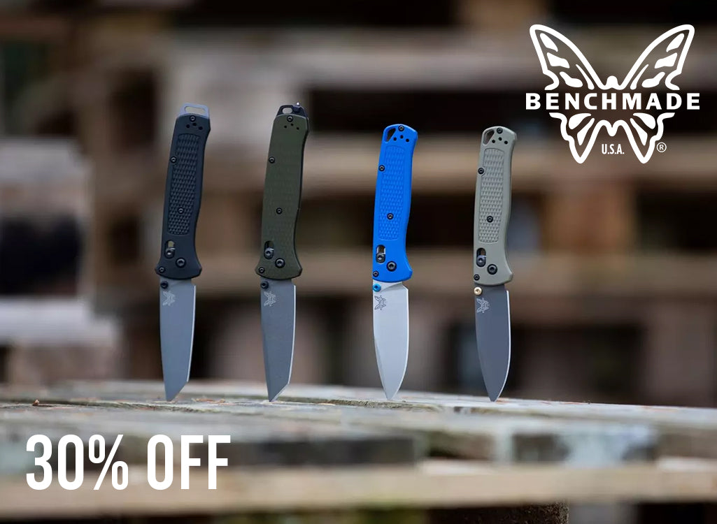 Four Benchmade folding knives with textured handles in black, olive green, bright blue, and gray, standing upright on a wooden surface with a blurred outdoor background. White text overlays read '30% OFF' at the bottom left and the 'BENCHMADE USA' logo at the top right.