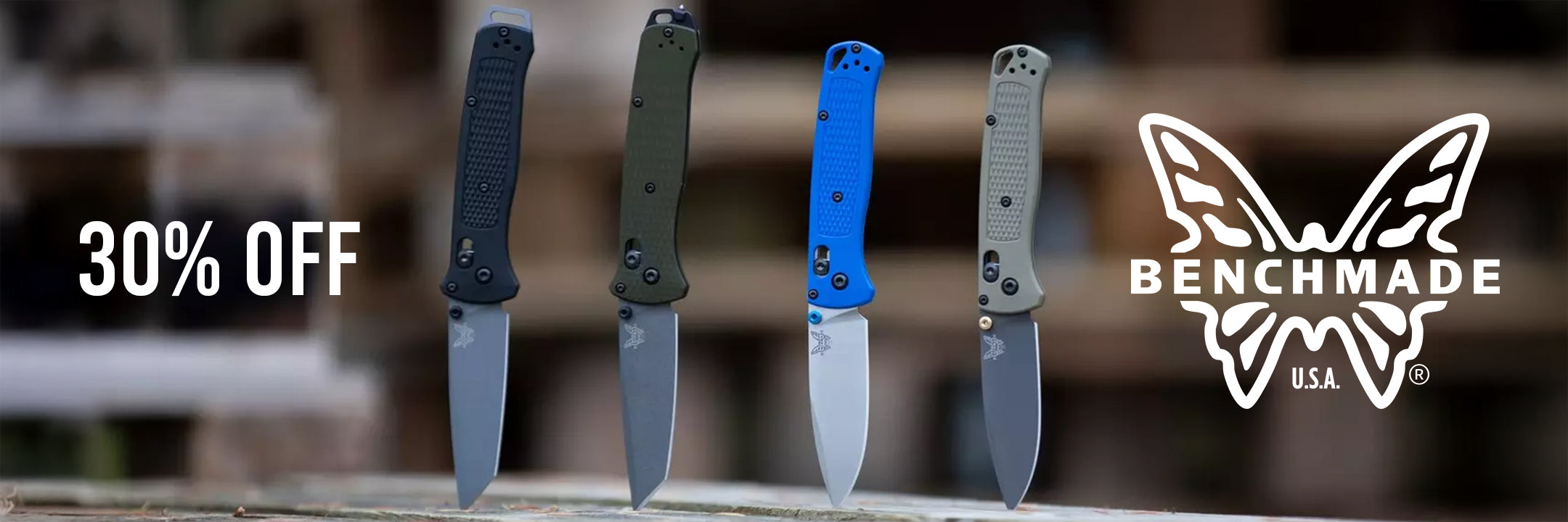 Four Benchmade folding knives in different handle colors (black, olive green, blue, and gray) standing upright on a wooden surface with a blurred outdoor background. Promotional text on the left reads '30% OFF' and the Benchmade logo is visible on the right.